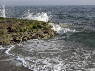 Sea waves hitting rocky shore