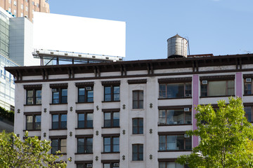 Big, white, blank, billboard on the red brick building.