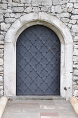 Old iron door and stone wall