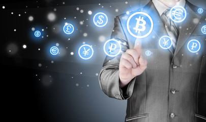 Choosing bitcoins, businessman pressing touch screen button.