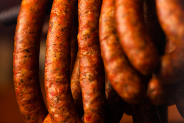 Traditional food. Smoked sausuages in smokehouse.