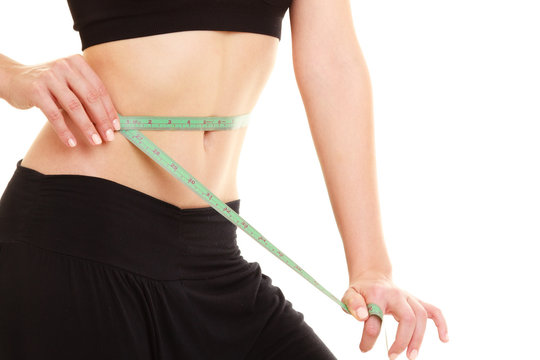 diet. slim fit girl with measure tape measuring waist