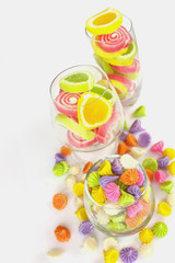 Colorful candy in glass saucer and bowl isolated on white backgr