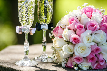 Wedding rings with roses and glasses of champagne