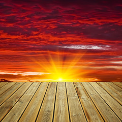 Wooden deck floor and sunset sky