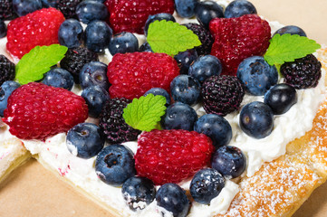 Fresh berry tart with cream overhead
