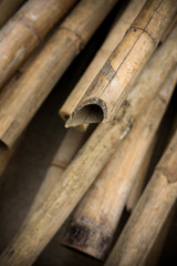 Close up background of dry thick bamboo poles with vignette