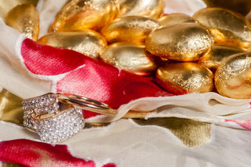  wedding rings on colorful fabric