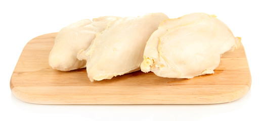 Boiled chicken breast on wooden cutting board isolated on white