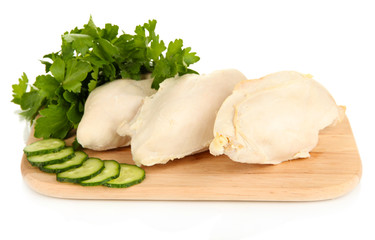 Boiled chicken breast on wooden cutting board isolated on white