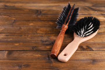 Wooden hairbrushes on wooden background