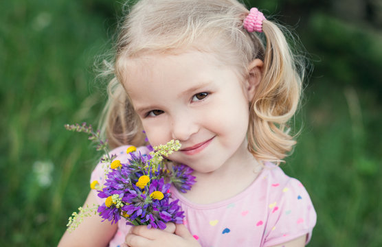 cute little girl holding a bouquet