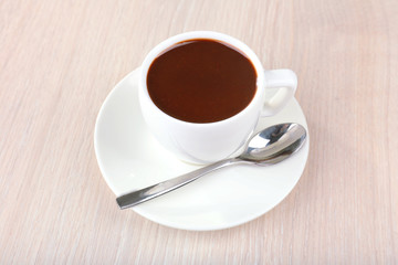 Cup of hot chocolate on table, close up