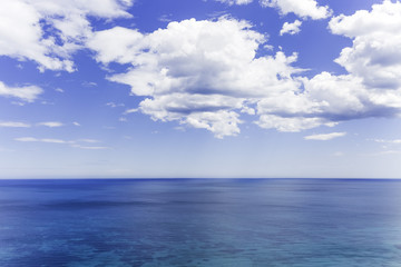 Naklejka na ściany i meble blue cloudy sky over the blue sea