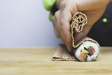 rolling up sushi