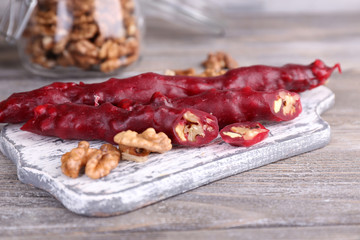 Tasty oriental sweets (churchkhela) and fresh nuts in glass