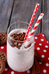 Milk cocktail with chocolate cookies on table close-up