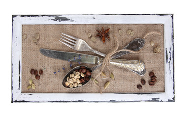 Wooden frame and vintage cutlery and spices  isolated on white