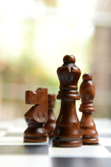 Chess board with chess pieces on light background