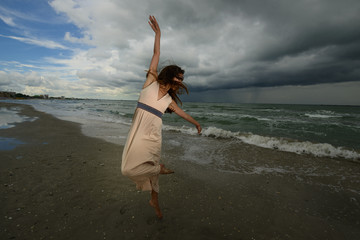 Young woman dancing on a beach