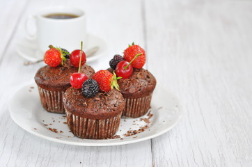 Chocolate muffins with berries, selective focus
