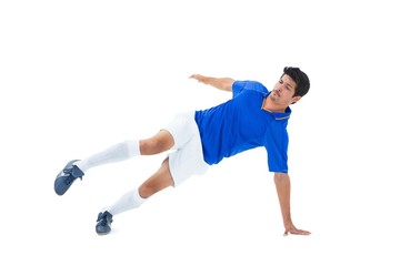 Football player in blue kicking