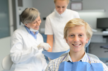 Fototapeta premium Teenage patient, dentist woman with dental assistant