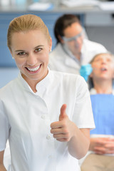 Dental assistant dentist checkup patient  thumbup