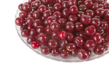 Fresh sweet red Cherries in glass plate isolated on white