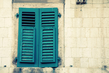 window with green shutters in old house, Italy