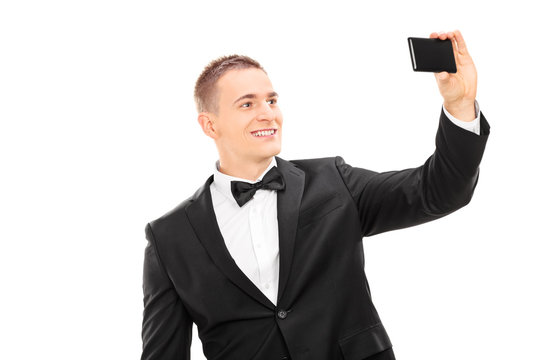 Elegant man taking a selfie with cell phone