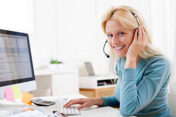 Young attractive blonde working in a call center