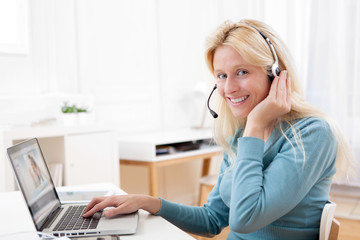 Young attractive woman blonde chatting on laptop