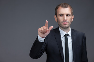 Portrait of executive pointing finger gestures, isolated