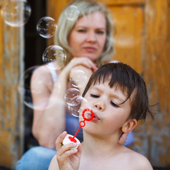 Little boy blow bubbles