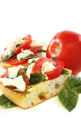 Sandwich with tomato, cheese and basil.