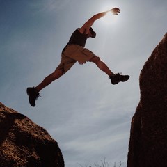 Man jumping between rocks