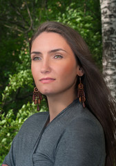 Portrait of a beautiful young brunette woman in summer