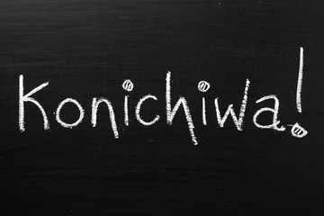 The Japanese word Konichiwa written on a blackboard
