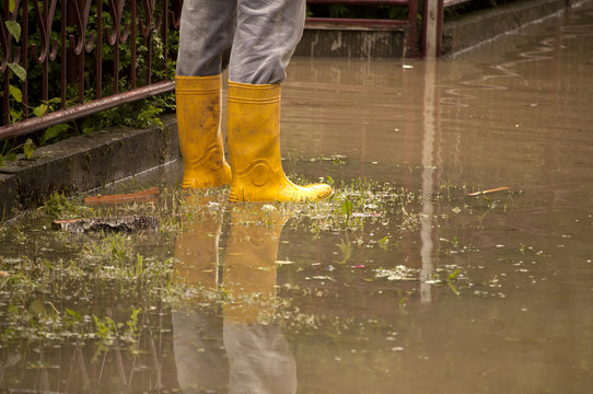 Man standing in a flooded yard
