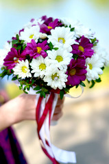 Hand holding wedding bouquet
