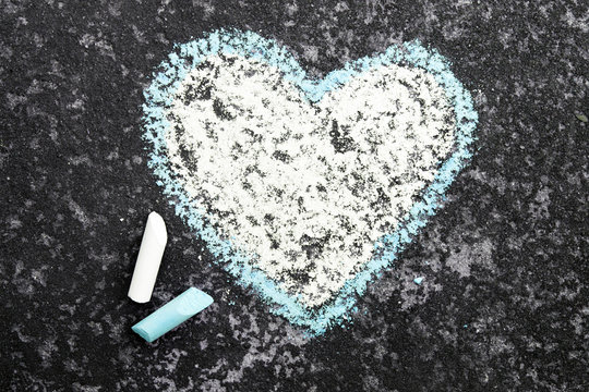 heart drawn in chalk on concrete