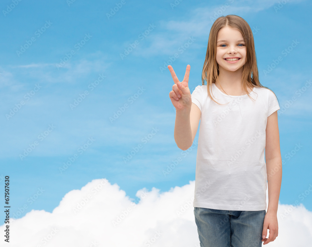 Poster little girl in white t-shirt showing peace gesture