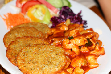 Chicken spicy sauce with potatoes flat cakes