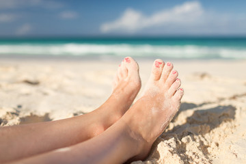 closeup of woman legs on sea shore