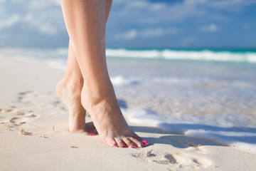 closeup of woman legs on sea shore