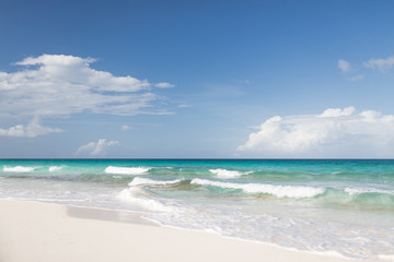 blue sea or ocean, white sand and sky with clouds