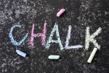 the word "chalk" written colorful chalk on the asphalt.