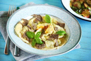 Ravioli pasta filled with ricotta, egg yolk and black truffles