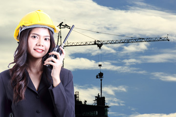 Engineer woman talking with a walkie talkie